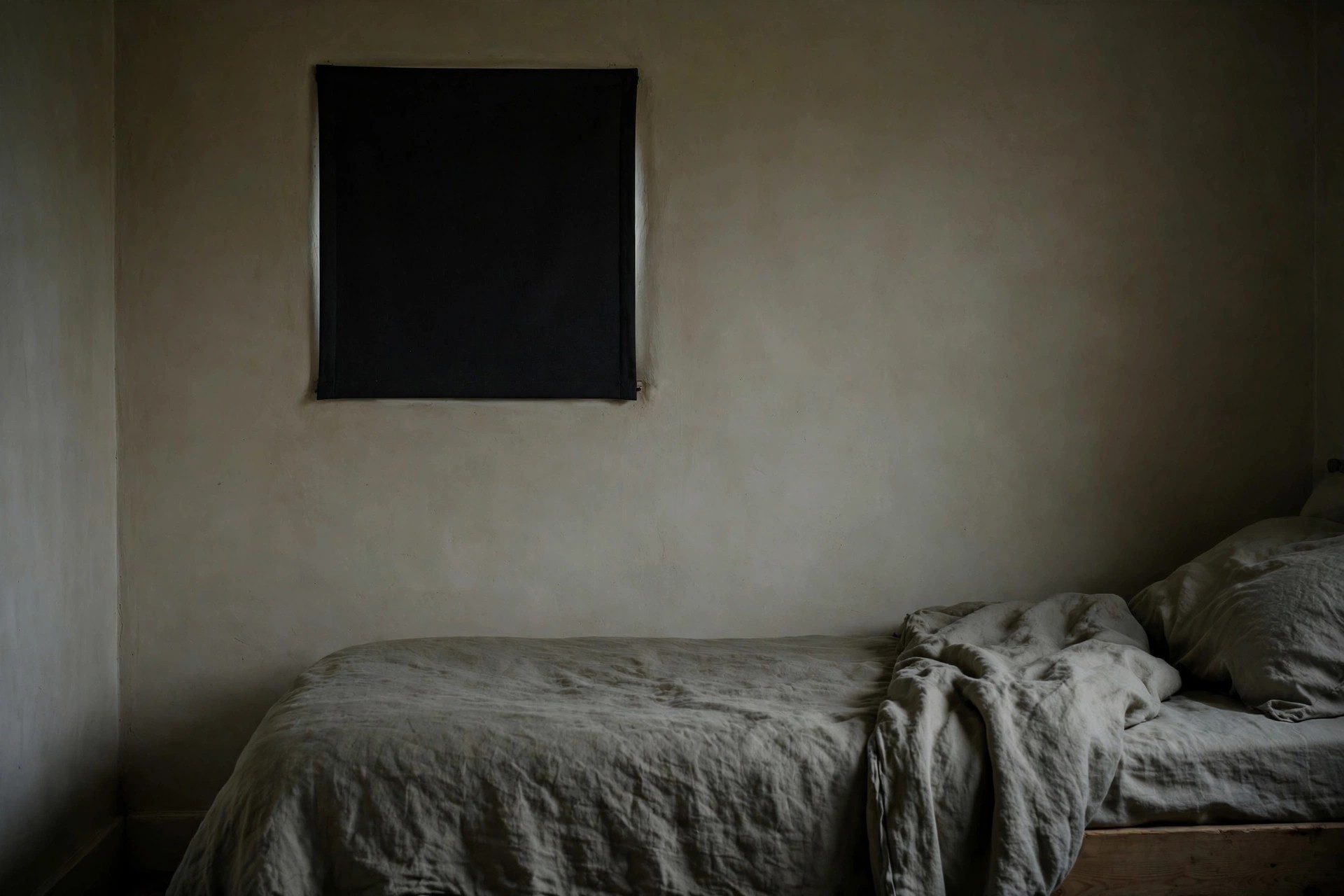 Small awkward bedroom window covered neatly with a plain blackout panel
