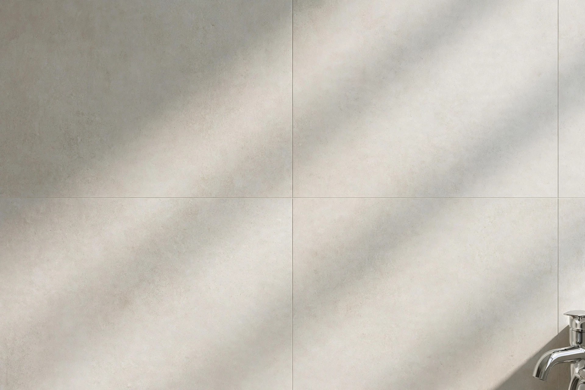 Close-up of pale bathroom tiles with colour-matched grout for a seamless wall